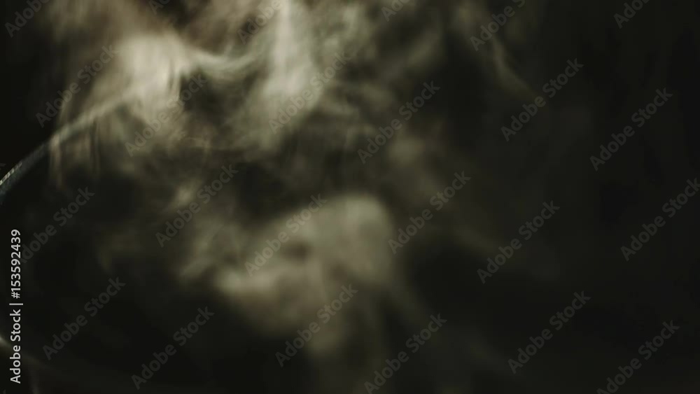 Boiling water with black background. Only steam with nobody. Simple abstraction texture. Boiling water with black background. Only steam with nobody. Simple abstraction texture.