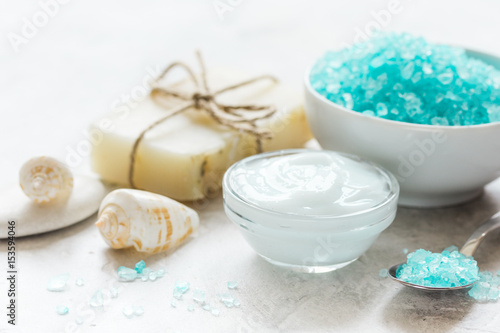 blue sea salt, soap and body cream on stone desk background