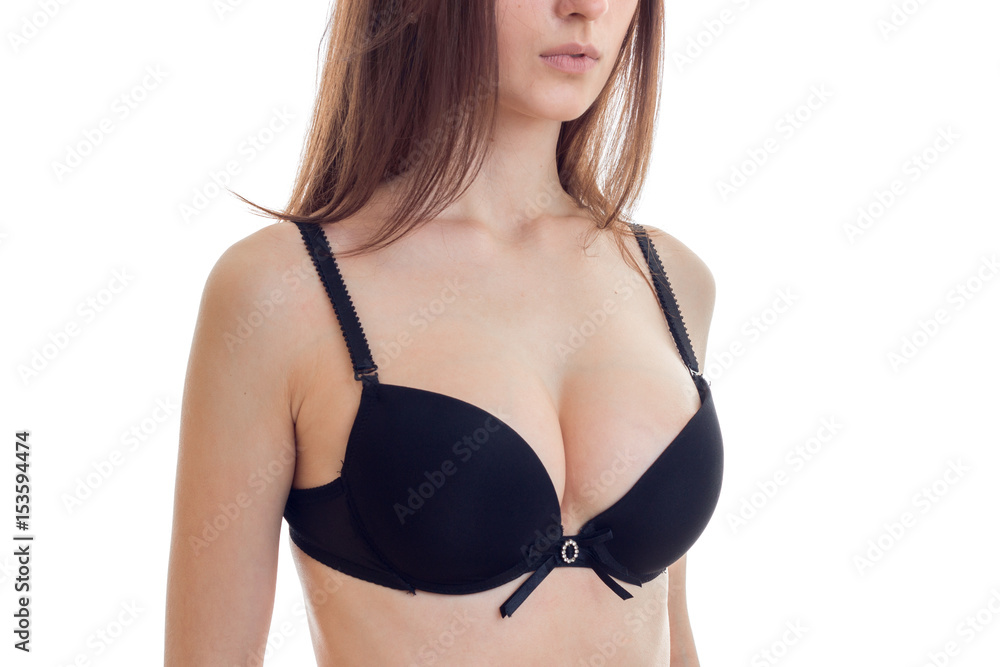 Foto de natural big sexy breasts in a black bra close-up do Stock