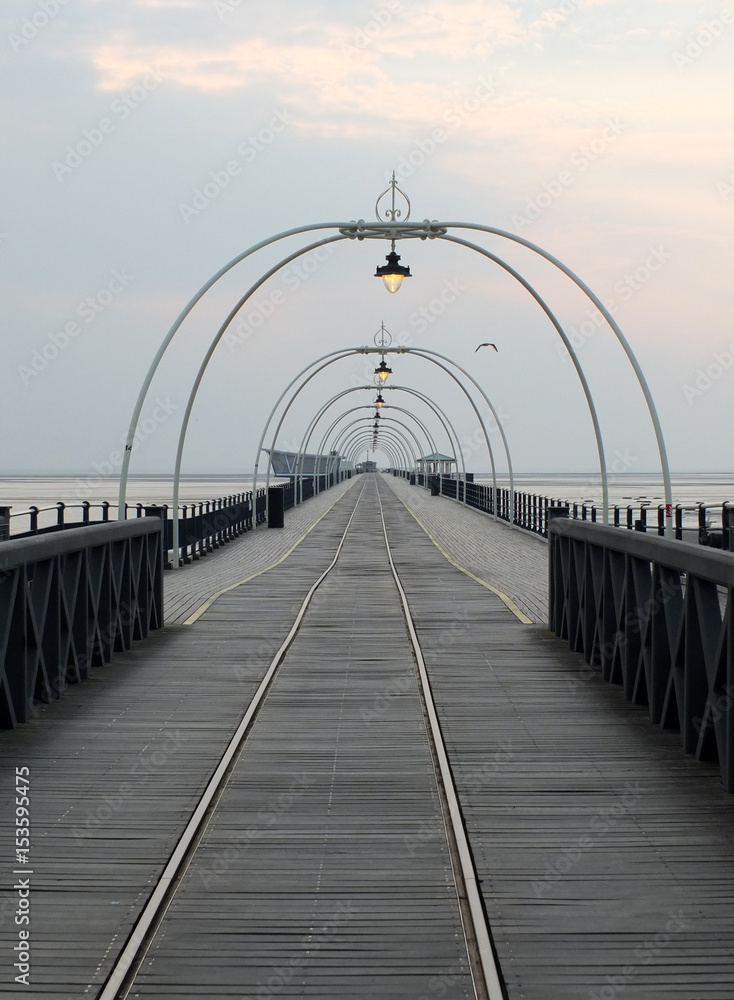 southport pier at sunset with walkway and tram lines