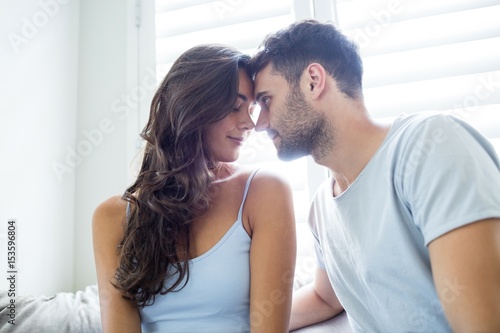Young couple romancing in bedroom
