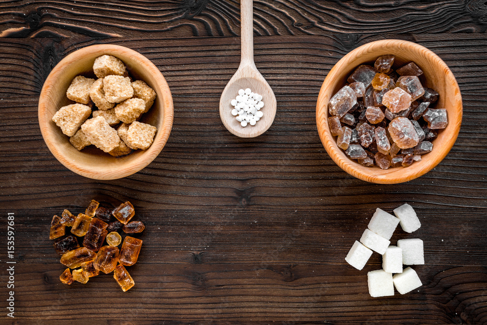 lumps of sugar in bowls on wooden table background top view lumps of sugar in bowls on wooden table background top view