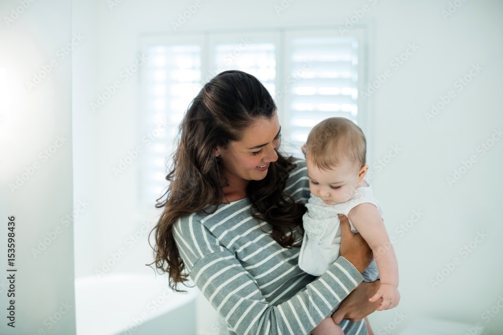 Mother holding her baby girl in the bathroom Mother holding her baby girl in the bathroom