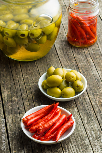 Pickled chili peppers and green olives. photo