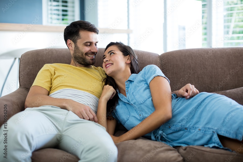 Smiling couple relaxing in the living room Smiling couple relaxing in the living room