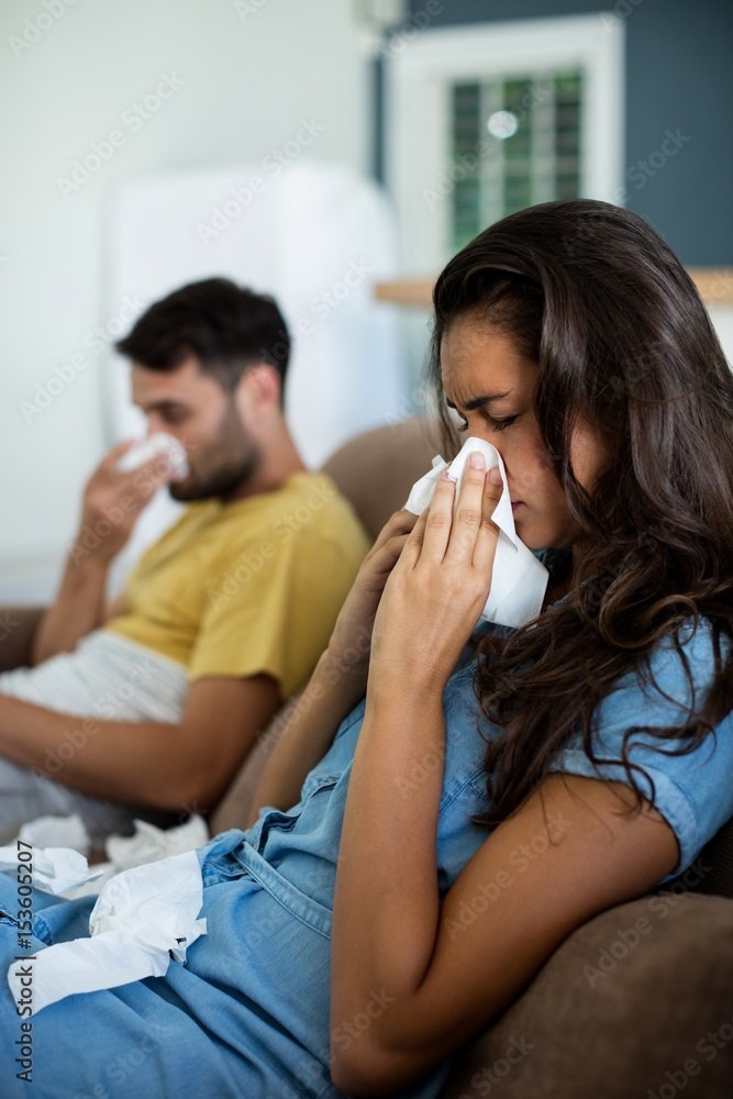 Couple ignoring each other in the living room Couple ignoring each other in the living room