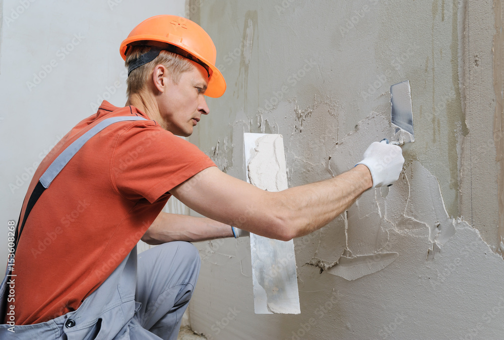 Worker is putting a gypsum plaste. Worker is putting a gypsum plaste.