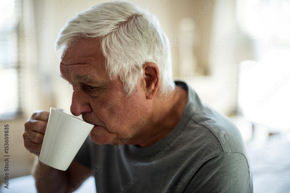Worried senior man having black coffee in the bedroom Worried senior man having black coffee in the bedroom