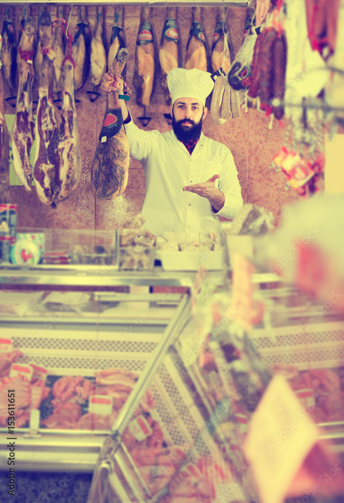 Fototapeta premium Male shop assistant demonstrating jamon