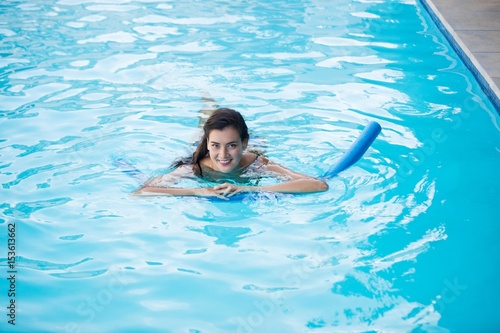 Young woman swimming with inflatable tube © WavebreakMediaMicro