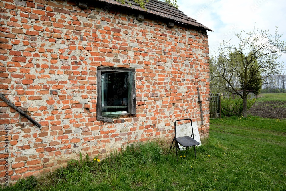 Tary rural building in the wilderness and lonely chair