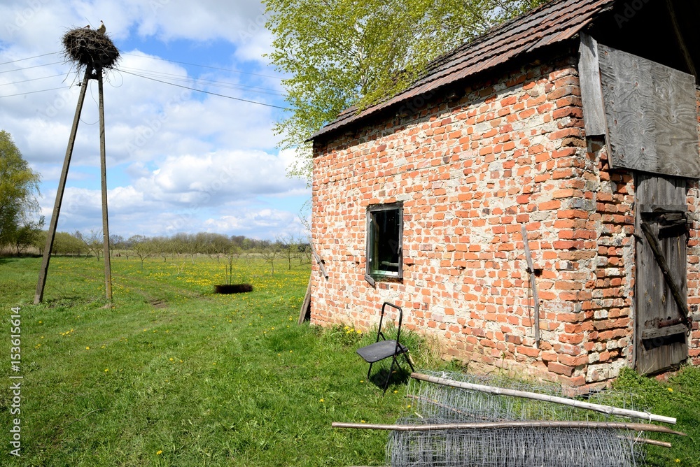 Old rural building in the wilderness and lonely chair