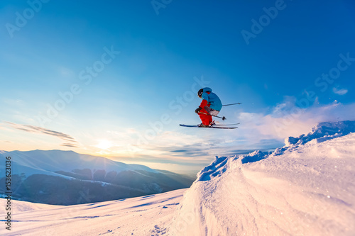 Good skiing in the snowy mountains, Carpathians, Ukraine. Beautiful winter sunset, incredible ski jump. photo