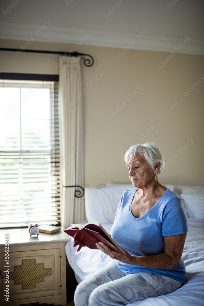 Senior woman reading a book in the bedroom Senior woman reading a book in the bedroom