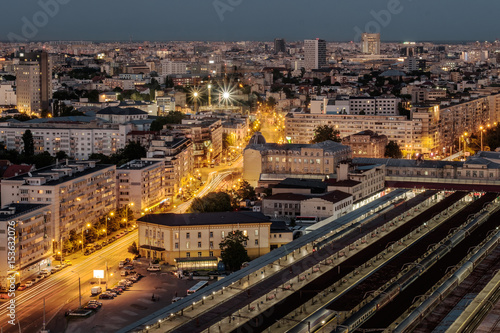 Aerial view of the Bucharest central train station - Bucharest Nord. Traffic and buildings after the sunset.