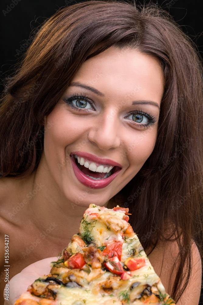 young woman with pizza against black background