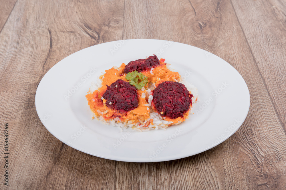 Vegetarian food on a plate with wooden background Vegetarian food on a plate with wooden background