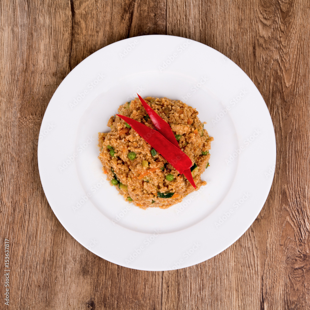 Vegetarian food on a plate with wooden background Vegetarian food on a plate with wooden background