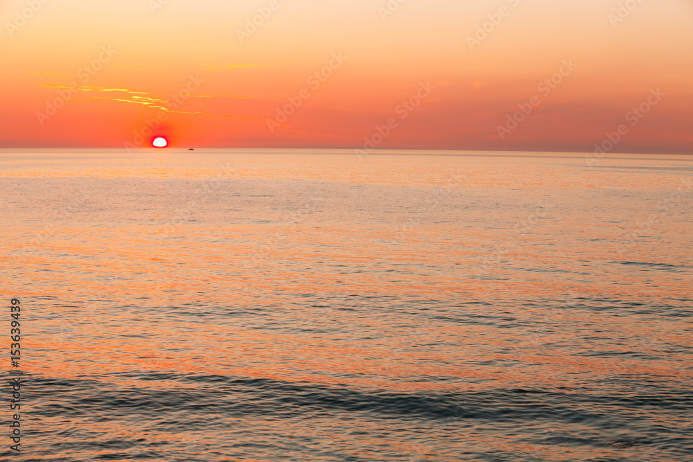 Sun Is Setting On Horizon At Sunset Sunrise Over Sea Or Ocean. T