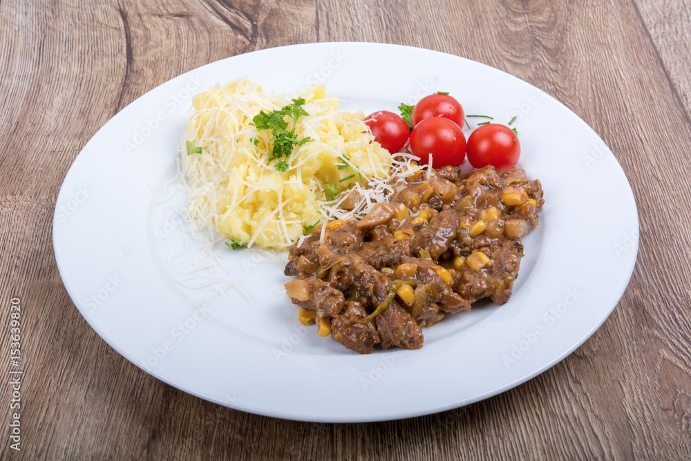 Vegetarian food on a plate with wooden background Vegetarian food on a plate with wooden background