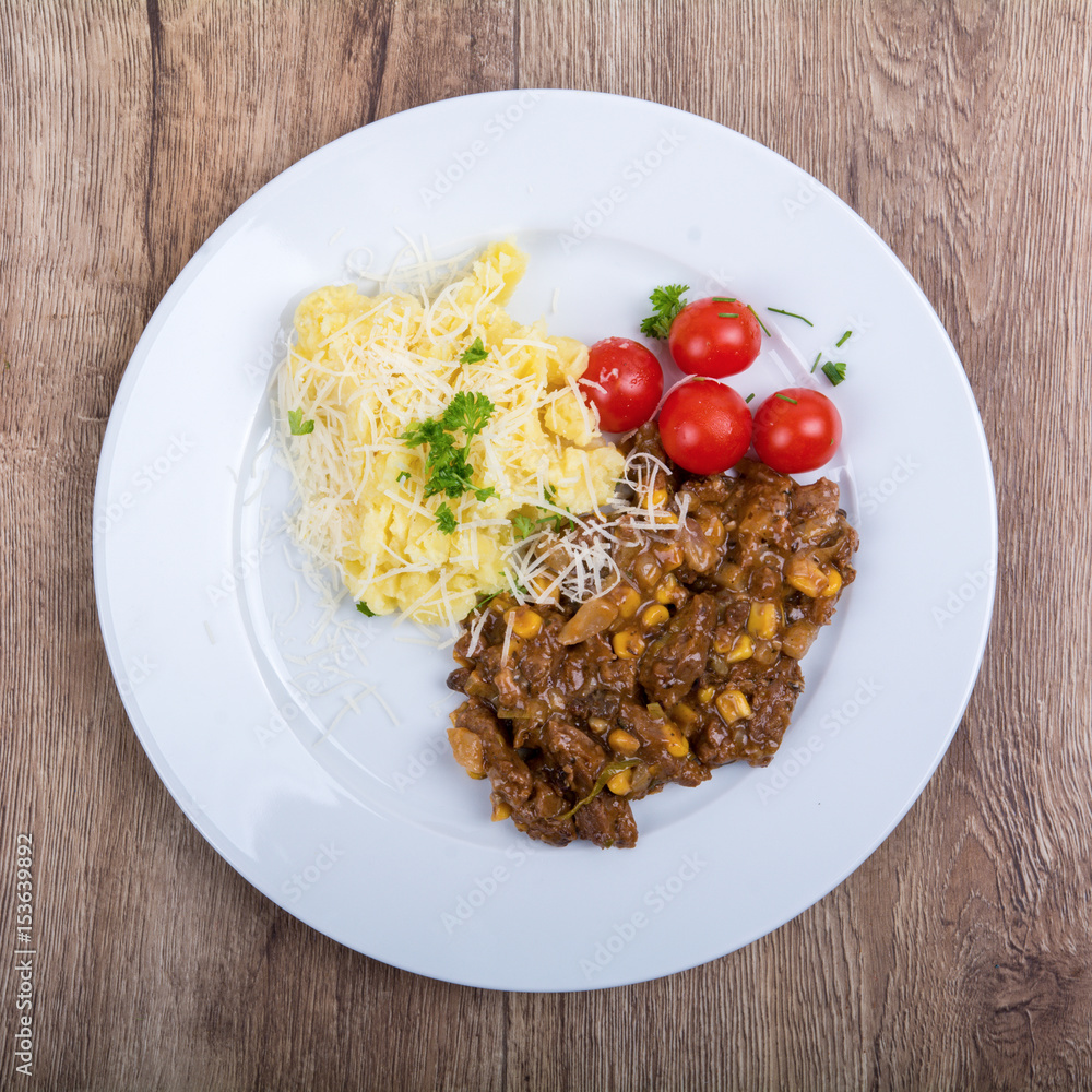 Vegetarian food on a plate with wooden background Vegetarian food on a plate with wooden background