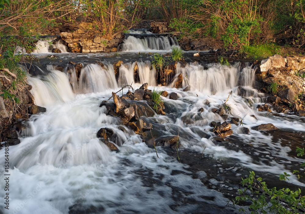 Waterfall at the sunset in forest big Waterfall at the sunset in forest big