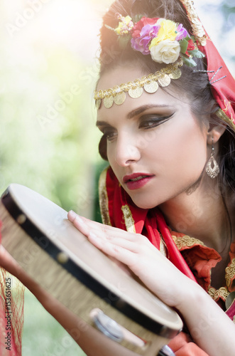Canvas Print Oriental Dancer with tambourine in the park