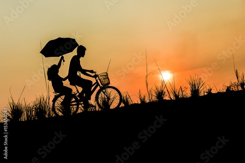 brother with sister riding bikes at sunset © doidam10