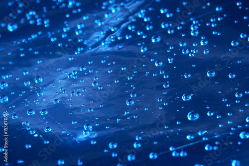 water drops on blue foil focus