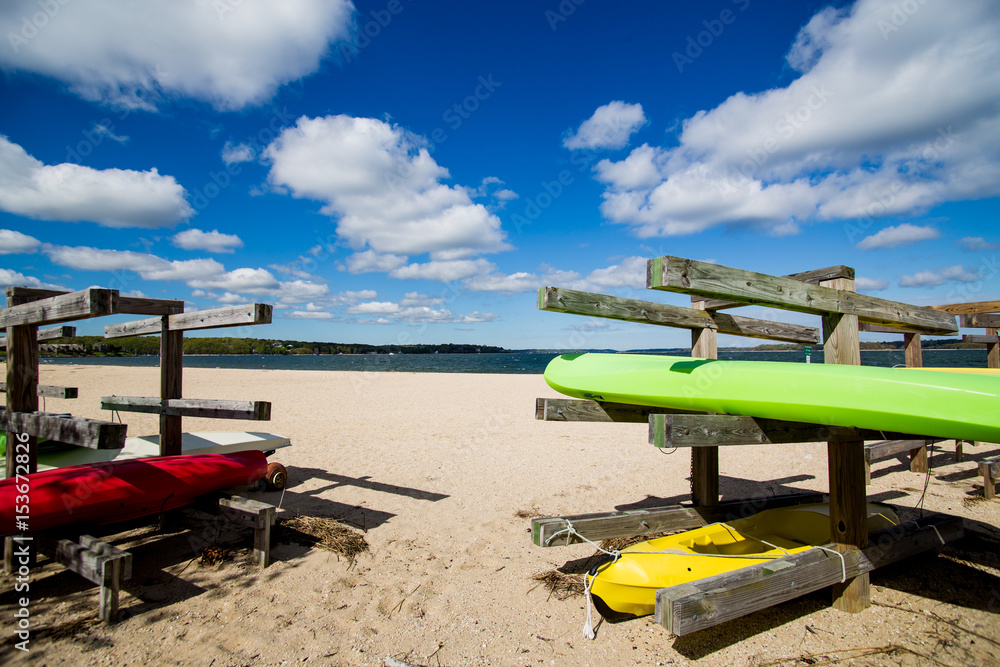 Colorful kayaks on wooden stands at the beach.Summer, outdoors, water sports and vacation concept 