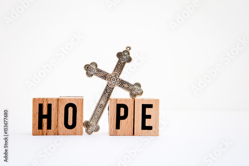 Quadro su tela Hope in wooden block letters with silver cross on white background