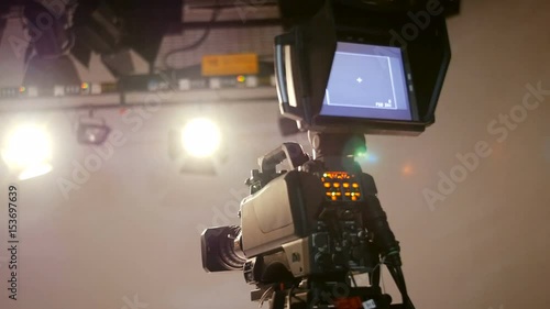 Professional Production Studio.
Interior of a production studio focusing on the camera with defocused studio lightings on top.
