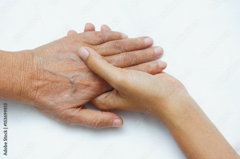 Fototapeta premium young hand hold older hand