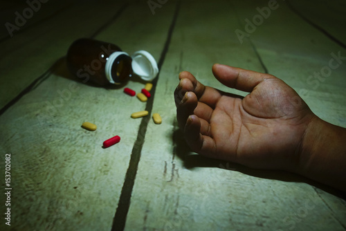 medicine bottle falls on the floor and spilled out capsule photo