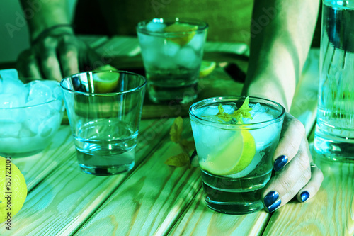 Female bartender offers alcoholic cocktail or non-alcoholic refreshing drink, cocktail, mohoto photo