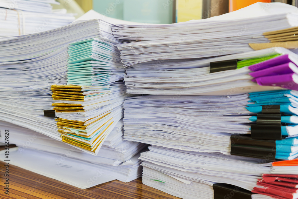 Pile of unfinished documents on office desk, Stack of business paper Pile of unfinished documents on office desk, Stack of business paper