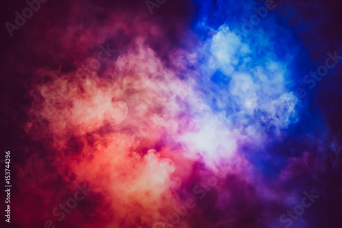 Abstract red and blue lighting mix together in the smoke background.