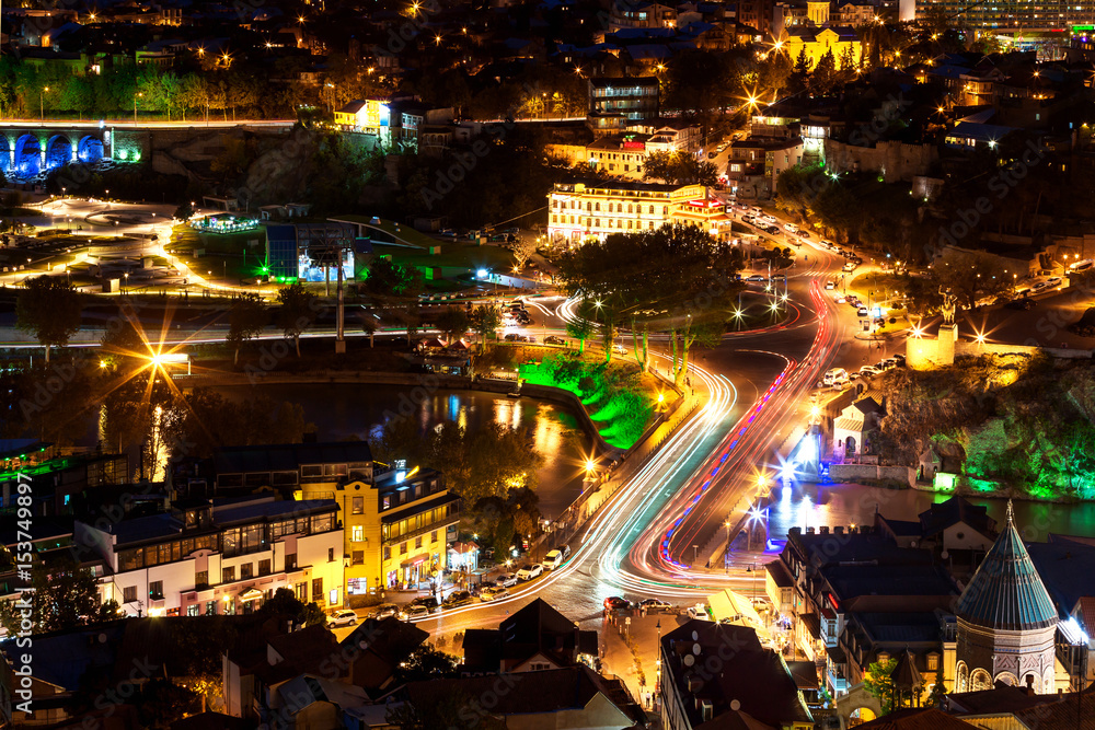 Night panorama view of Tbilisi, capital of Georgia country. Meidani square at night with illumination and moving cars.