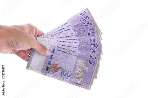 Isolated hand holding some 100 Malaysian Ringgit