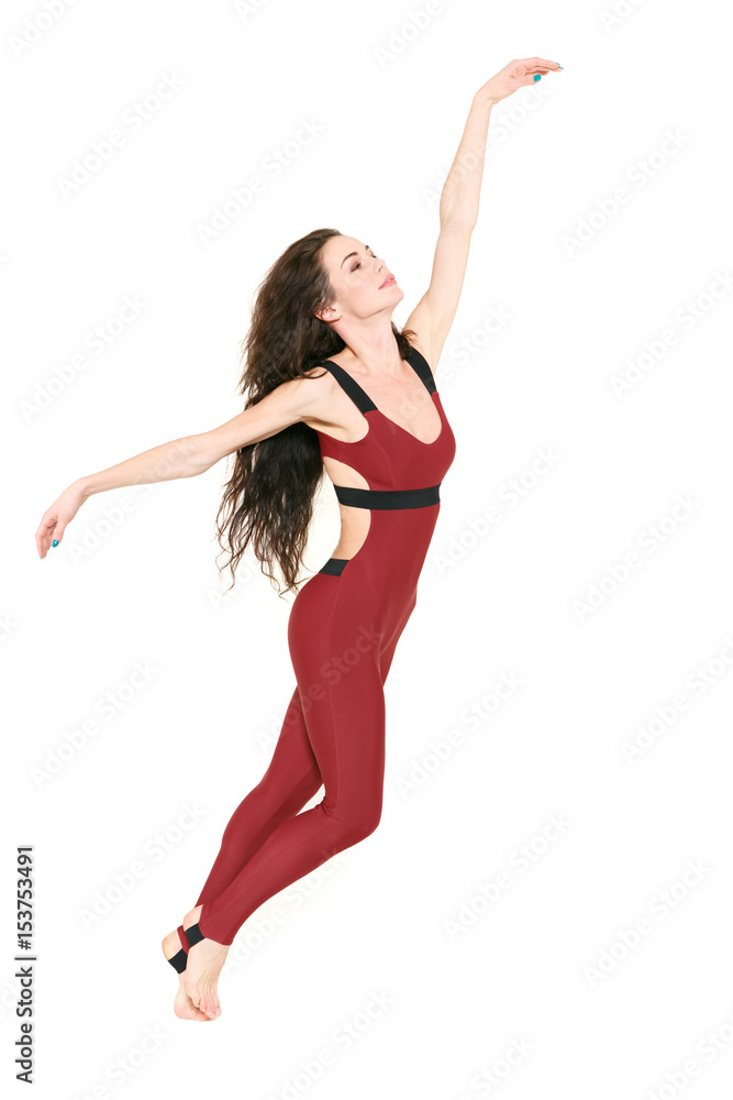 Feeling so light. Shot of a beautiful brunette woman practicing her dance moves isolated on white