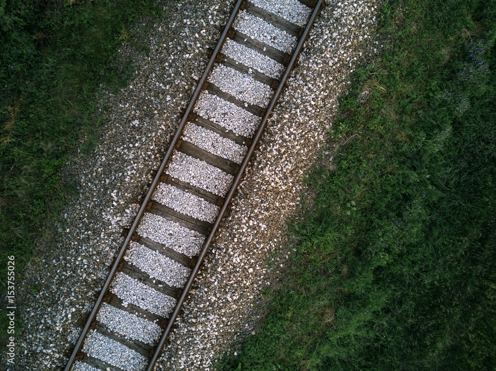 Fototapeta premium Aerial view of railway track through countryside, drone top view