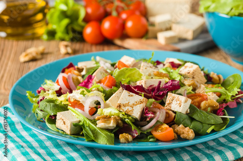 Delicious salad with tofu, tomatoes and walnuts.