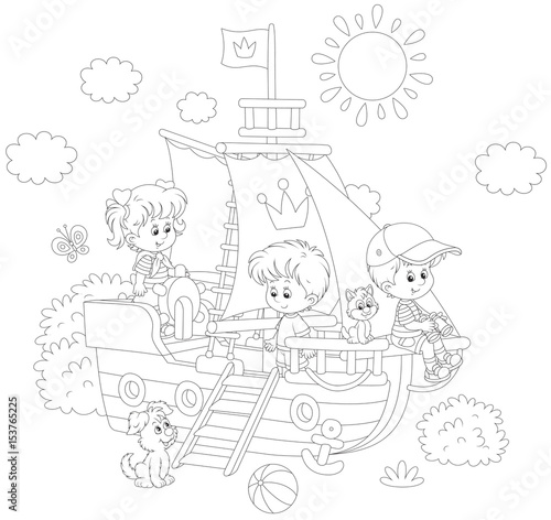 Little children playing on a toy sailing ship at a playground in a park