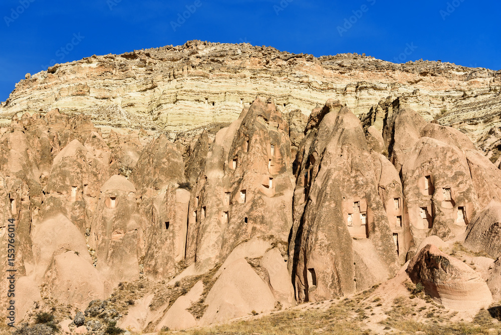 Fototapeta premium View of cave houses in valley at Cavusin. Cappadocia. Turkey