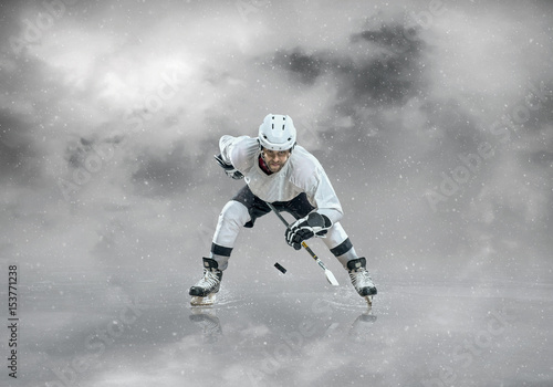 Ice hockey player in sport action on the ice under sky