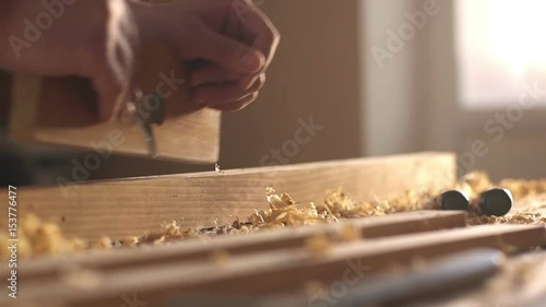 A man sawing wood Board with hand saw. Closeup. Slow motion