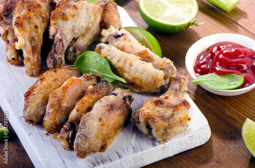 Chicken wings with celery on wooden table