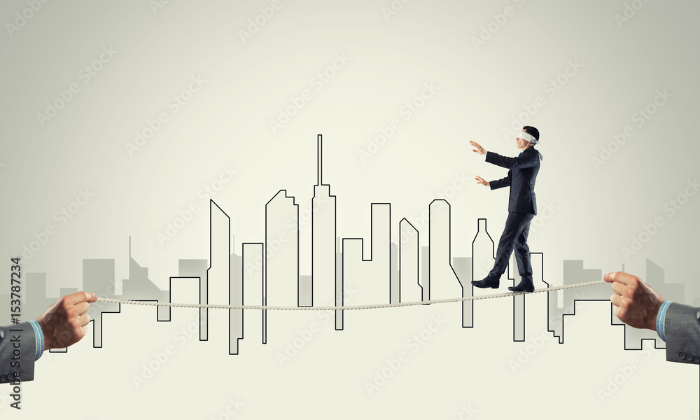 Business concept of risk support and assistance with man balancing on rope