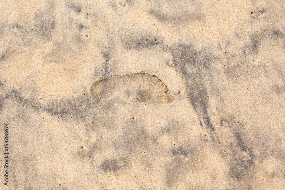 Foot trace on a sandy beach.