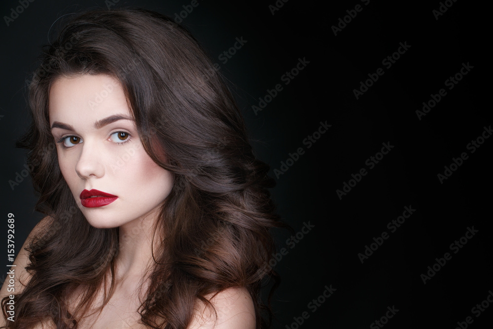 Confidence in her eyes. Studio shot of a beautiful young female posing in studio on black background copyspace on the side. Confidence in her eyes. Studio shot of a beautiful young female posing in studio on black background copyspace on the side.
